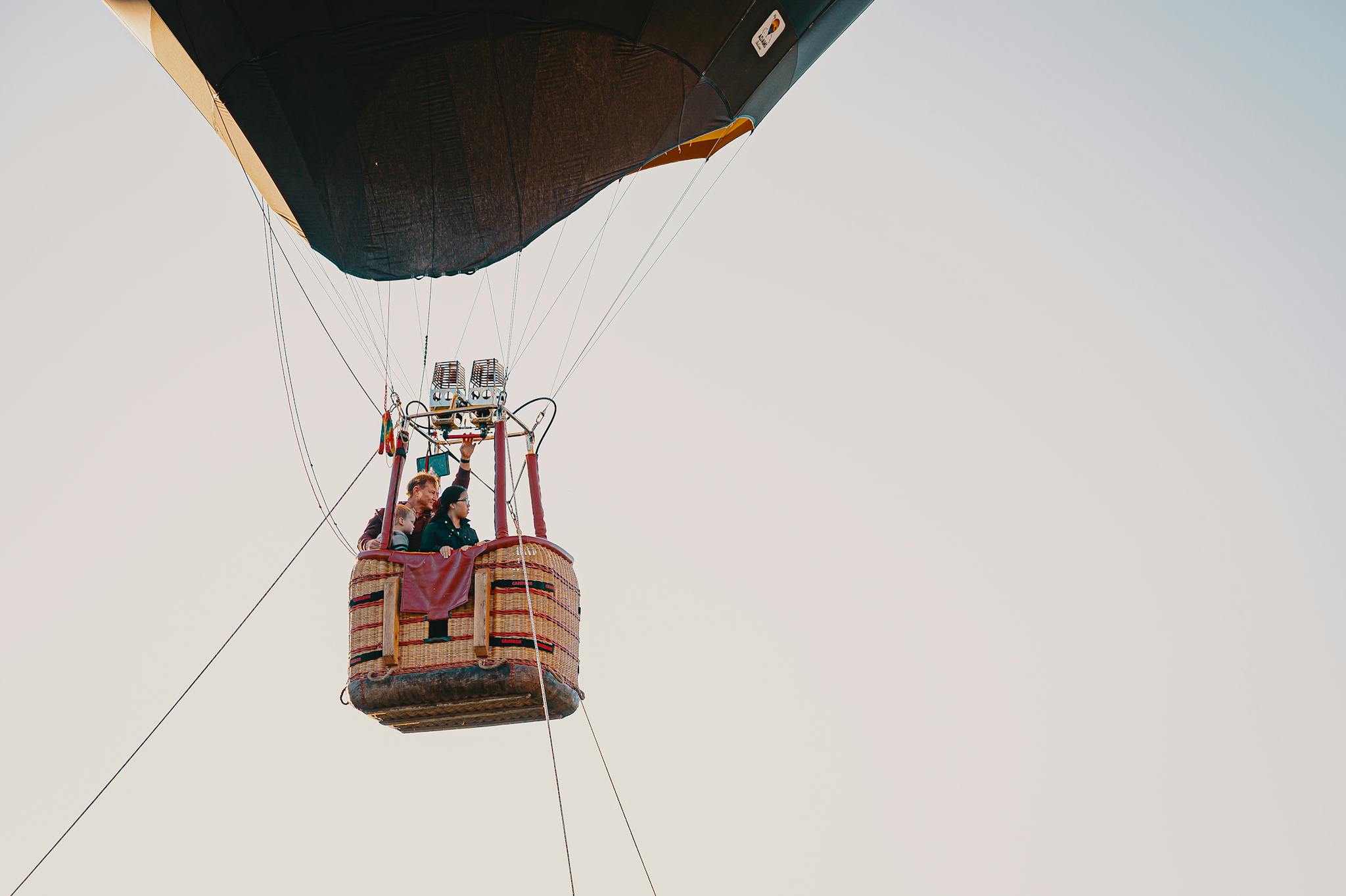 Experience an exciting journey in a hot air balloon soaring high against a clear sky.